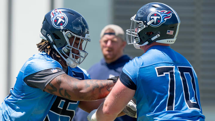 Offensivle lineman JC Latham (55) and Cole Spencer (70) run drills during Tennessee Titans practice at Ascension Saint Thomas Sports Park in Nashville, Tenn., Tuesday, May 21, 2024.