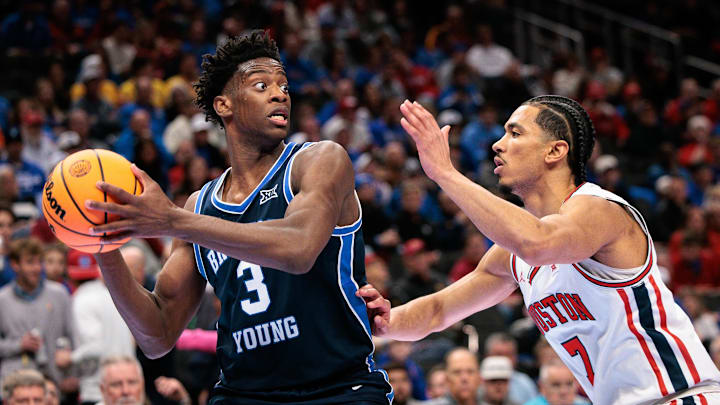 Mar 12, 2026; Kansas City, MO, USA; BYU Cougars forward AJ Dybantsa (3) protects the ball from Houston Cougars guard Milos Uzan (7) during the second half at T-Mobile Center. Mandatory Credit: William Purnell-Imagn Images