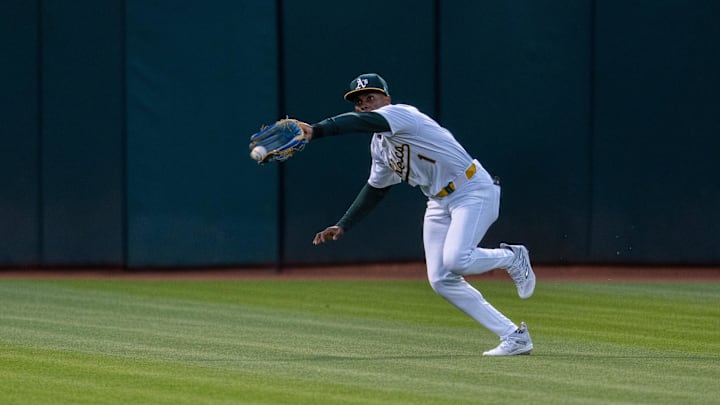 May 6, 2024; Oakland, California, USA; Oakland Athletics outfielder Esteury Ruiz (1) fields a fly ball during the sixth inning against the Texas Rangers at Oakland-Alameda County Coliseum. Mandatory Credit: Neville E. Guard-Imagn Images