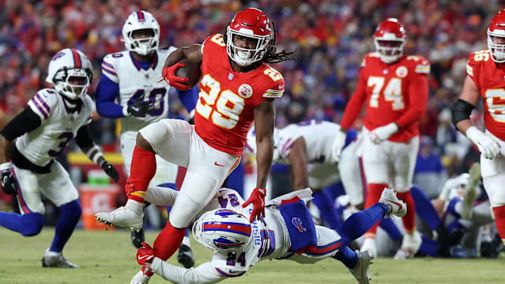 Jan 26, 2025; Kansas City, MO, USA; Kansas City Chiefs running back Kareem Hunt (29) breaks a tackle against Buffalo Bills safety Cole Bishop (24) during the first quarter in the AFC Championship game at GEHA Field at Arrowhead Stadium. Mandatory Credit: Mark J. Rebilas-Imagn Images