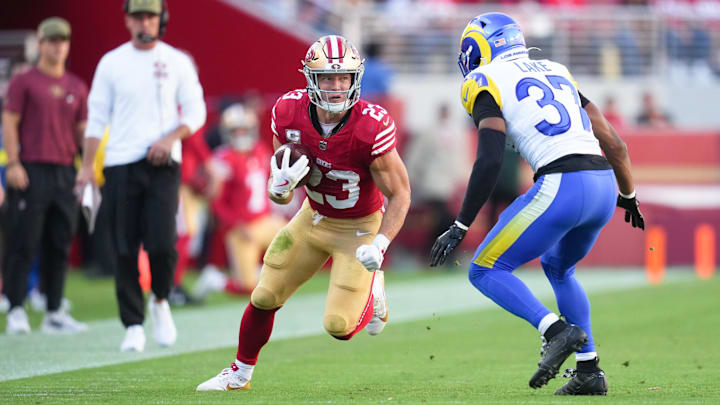 Nov 9, 2025; Santa Clara, California, USA; San Francisco 49ers running back Christian McCaffrey (23) runs the ball against Los Angeles Rams safety Quentin Lake (37) during the second quarter at Levi's Stadium. Mandatory Credit: Cary Edmondson-Imagn Images