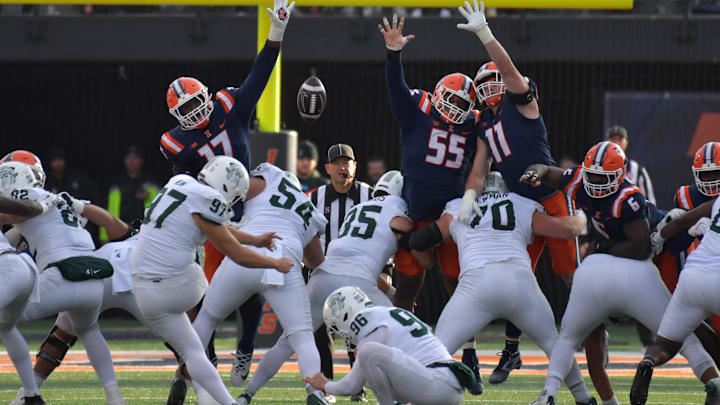 Nov 16, 2024; Champaign, Illinois, USA; Michigan State Spartans kicker Jonathon Kim (97) kicks a field goal as Illinois Fighting Illini linebacker Gabe Jacas (17), defensive lineman Jeremiah Warren (55) and defensive lineman Alex Bray (11) try to block during the first half at Memorial Stadium. Mandatory Credit: Ron Johnson-Imagn Images
