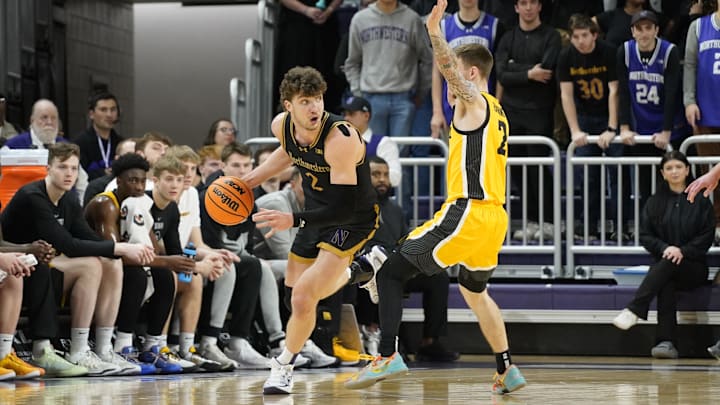 Feb 28, 2025; Evanston, Illinois, USA; Iowa Hawkeyes guard Brock Harding (2) defends Northwestern Wildcats forward Nick Martinelli (2) during the first half at Welsh-Ryan Arena. Mandatory Credit: David Banks-Imagn Images