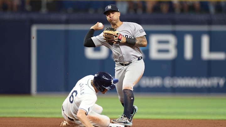 Jul 10, 2024; St. Petersburg, Florida, USA; New York Yankees second baseman Gleyber Torres (25) attempts a double play against the Tampa Bay Rays in the fifth inning  at Tropicana Field. Mandatory Credit: Nathan Ray Seebeck-USA TODAY Sports