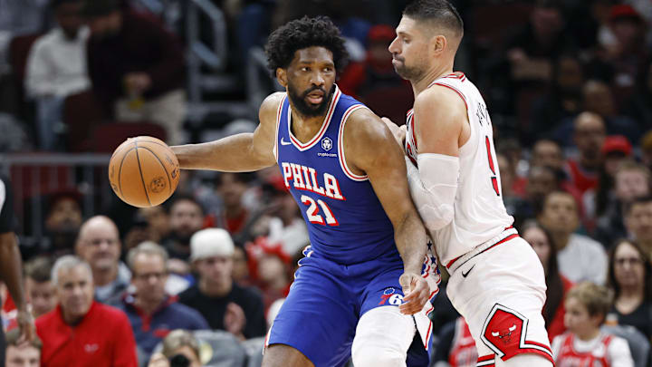 Dec 8, 2024; Chicago, Illinois, USA; Chicago Bulls center Nikola Vucevic (9) defends against Philadelphia 76ers center Joel Embiid (21) during the first half at United Center. Mandatory Credit: Kamil Krzaczynski-Imagn Images