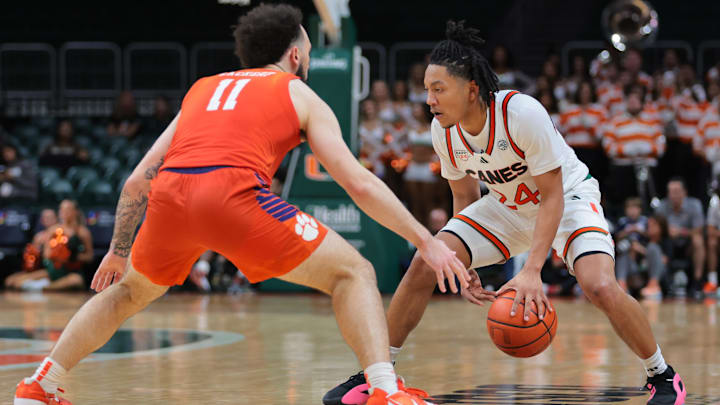 Dec 7, 2024; Coral Gables, Florida, USA; Miami Hurricanes guard Nijel Pack (24) dribbles the basketball as Clemson Tigers guard Jaeden Zackery (11) defends during the second half at Watsco Center. Mandatory Credit: Sam Navarro-Imagn Images