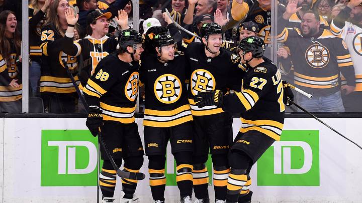 Sep 29, 2026; Boston, Massachusetts, USA;  Boston Bruins forward JJ Peterka celebrates his goal with right wing David Pastrnak (88) defenseman Will Borgen (17) and defenseman Hampus Lindholm (27) during the third period against the New York Rangers at TD Garden. Mandatory Credit: Bob DeChiara-Imagn Images