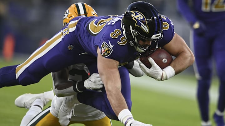 Dec 19, 2021; Baltimore, Maryland, USA; Baltimore Ravens tight end Mark Andrews (89) dives forward as Green Bay Packers defensive back Chandon Sullivan (39) defends during the first quarter  at M&T Bank Stadium. Mandatory Credit: Tommy Gilligan-Imagn Images