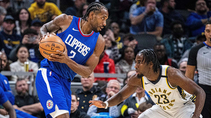 Dec 18, 2023; Indianapolis, Indiana, USA;  LA Clippers forward Kawhi Leonard (2) holds the ball while Indiana Pacers forward Aaron Nesmith (23) defends in the second half at Gainbridge Fieldhouse. Mandatory Credit: Trevor Ruszkowski-Imagn Images