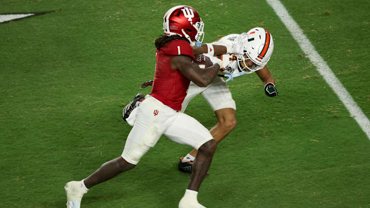 Jan 19, 2026; Miami Gardens, FL, USA; Indiana Hoosiers running back Roman Hemby (1) carries the ball defended by Miami Hurricanes defensive back Ethan O'Connor (24) in the fourth quarter during the College Football Playoff National Championship game at Hard Rock Stadium. Mandatory Credit: Kim Klement Neitzel-Imagn Images