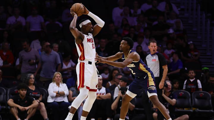 Oct 13, 2024; Miami, Florida, USA; Miami Heat center Bam Adebayo (13) protects the basketball from New Orleans Pelicans forward Herbert Jones (2) during the first quarter at Kaseya Center.