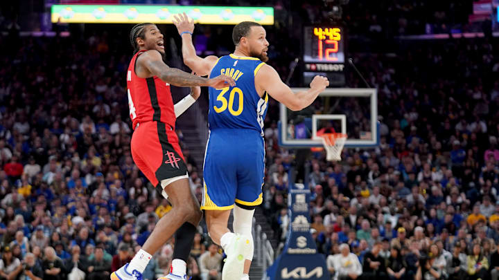 Apr 6, 2025; San Francisco, California, USA; Houston Rockets guard Jalen Green (4) reacts after making a three point basket next to Golden State Warriors guard Stephen Curry (30) in the fourth quarter at the Chase Center. Mandatory Credit: Cary Edmondson-Imagn Images