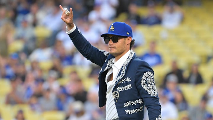 Sep 30, 2025; Los Angeles, California, USA; Former Los Angeles Dodgers pitcher Joe Kelly throws the ceremonial first pitch before the game between the Los Angeles Dodgers and Cincinnati Reds during game one of the Wildcard round for the 2025 MLB playoffs at Dodger Stadium. Mandatory Credit: Jayne Kamin-Oncea-Imagn Images