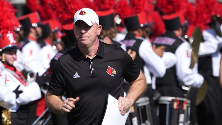 Louisville head coach Jeff Brohm ran out onto the field before the game against SMU