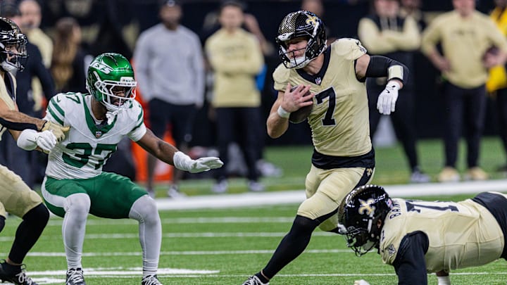 Dec 21, 2025; New Orleans, Louisiana, USA;  New Orleans Saints tight end Taysom Hill (7) runs with the ball against New York Jets cornerback Qwan'Tez Stiggers (37) during the first half  at Caesars Superdome. Mandatory Credit: Stephen Lew-Imagn Images