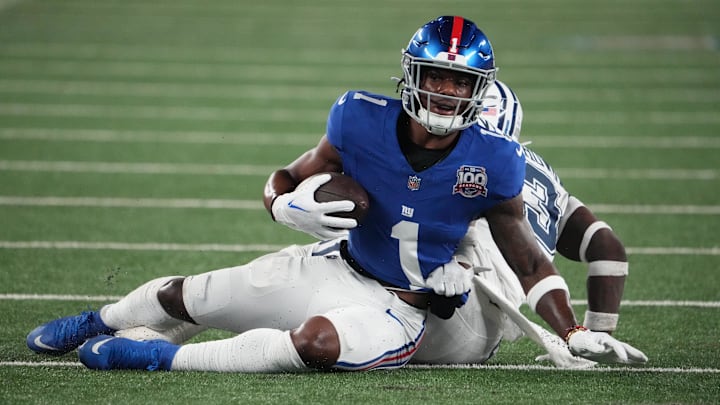 Sep 26, 2024; East Rutherford, New Jersey, USA;  New York Giants wide receiver Malik Nabers (1) on a short gain against Dallas Cowboys linebacker DeMarvion Overshown (13) during the first half at MetLife Stadium. Mandatory Credit: Robert Deutsch-Imagn Images