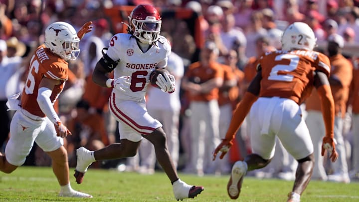 Oklahoma Sooners running back Tory Blaylock (6) looks to get by Texas Longhorns defensive back Michael Taaffe (16) and Texas Longhorns defensive back Derek Williams Jr. (2) in the first half of the Red River Rivalry college football game between the University of Oklahoma Sooners and the Texas Longhorn at the Cotton Bowl Stadium in Dallas, Texas, Saturday, Oct. 11, 2025.
