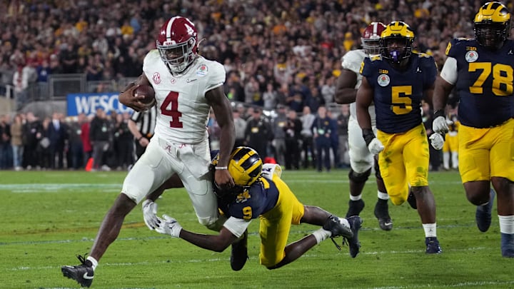 Jan 1, 2024; Pasadena, CA, USA; Alabama Crimson Tide quarterback Jalen Milroe (4) is tackled by Michigan Wolverines defensive back Rod Moore (9) during overtime in the 2024 Rose Bowl college football playoff semifinal game at Rose Bowl. Mandatory Credit: Kirby Lee-Imagn Images