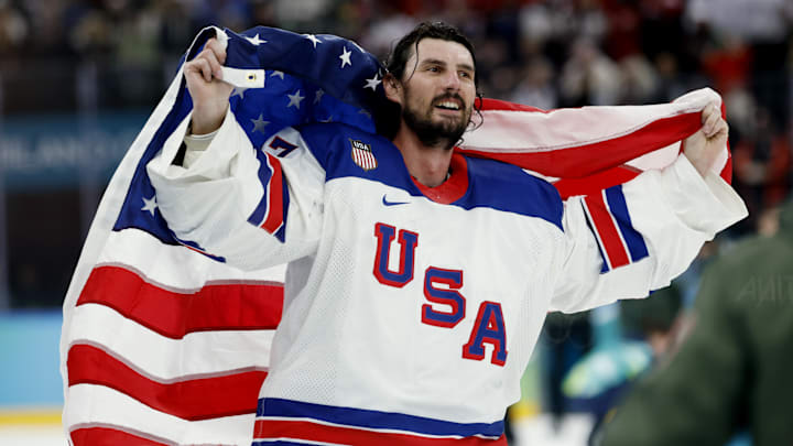 Feb 22, 2026; Milan, Italy;  Connor Hellebuyck (37) of the United States celebrates after defeating Canada in the men's ice hockey gold medal game during the Milano Cortina 2026 Olympic Winter Games at Milano Santagiulia Ice Hockey Arena.