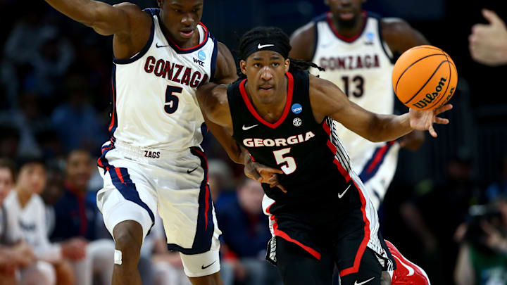 Mar 20, 2025; Wichita, KS, USA; Georgia Bulldogs guard Silas Demary Jr. (5) dribbles against Gonzaga Bulldogs forward Emmanuel Innocenti (5) in the second half of a first round men’s NCAA Tournament game at Intrust Bank Arena. Mandatory Credit: Nick Tre. Smith-Imagn Images