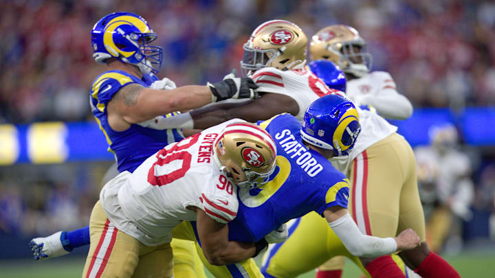 San Francisco 49ers defensive tackle Kevin Givens (90) hits Los Angeles Rams quarterback Matthew Stafford (9) San Francisco 49ers defensive tackle Kevin Givens (90) hits Los Angeles Rams quarterback Matthew Stafford (9)