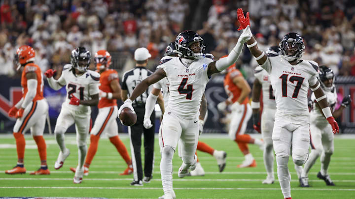 Sep 15, 2024; Houston, Texas, USA; Houston Texans cornerback Kamari Lassiter (4) celebrates his interception against the Chicago Bears in the second half at NRG Stadium. Mandatory Credit: Thomas Shea-Imagn Images
