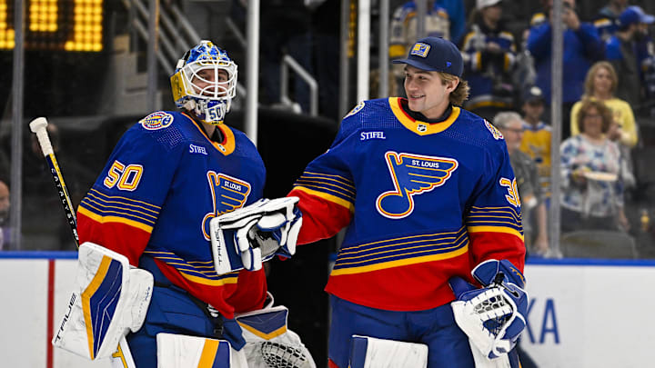 Mar 13, 2024; St. Louis, Missouri, USA;  St. Louis Blues goaltender Jordan Binnington (50) celebrates with goaltender Joel Hofer (30) after the Blues defeated the Los Angeles Kings at Enterprise Center. Mandatory Credit: Jeff Curry-Imagn Images