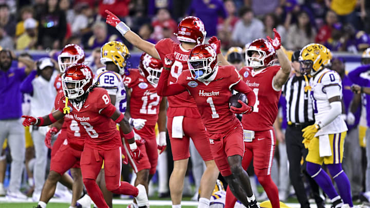 Dec 27, 2025; Houston, TX, USA; Houston Cougars defensive back Latrell McCutchin Sr. (1) recovers the onside kick during the second half against the Louisiana State Tigers at NRG Stadium. Mandatory Credit: Maria Lysaker-Imagn Images 