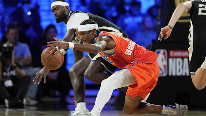 Dec 17, 2024; Las Vegas, Nevada, USA; Oklahoma City Thunder guard Shai Gilgeous-Alexander (2) and Milwaukee Bucks forward Bobby Portis (9) fight for a loose ball during the 3rd quarter of the Emirates NBA Cup championship game at T-Mobile Arena. Mandatory Credit: Kyle Terada-Imagn Images