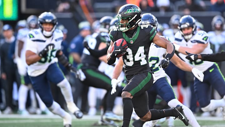 Dec 1, 2024; East Rutherford, New Jersey, USA; New York Jets running back Kene Nwangwu (34) returns a kickoff for a touchdown during the second quarter against the Seattle Seahawks at MetLife Stadium. 
