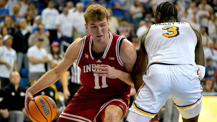 Jan 31, 2026; Los Angeles, California, USA; Indiana Hoosiers forward Trent Sisley (11) is fouled by UCLA Bruins guard Eric Dailey Jr. (3) as he drives to the basket in the second half at Pauley Pavilion presented by Wescom Financial. Mandatory Credit: Jayne Kamin-Oncea-Imagn Images