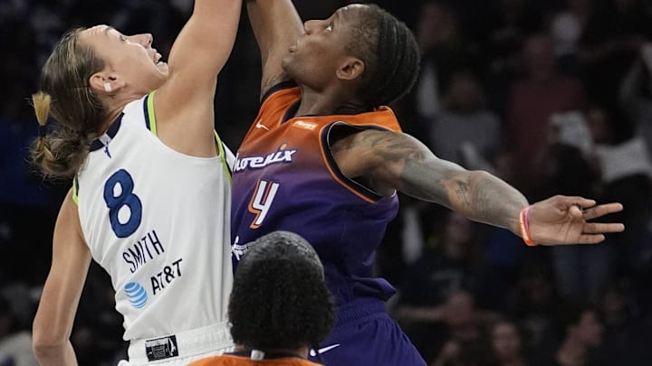 Jul 16, 2025; Minneapolis, Minnesota, USA; Minnesota Lynx forward Alanna Smith (8) and Phoenix Mercury forward Natasha Mack (4) jump for the ball to start the game at Target Center. Mandatory Credit: Bruce Kluckhohn-Imagn Images