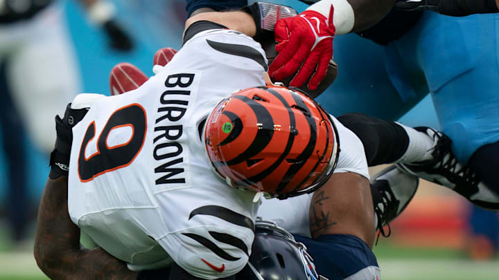 Tennessee Titans linebacker Harold Landry III (58) sacks Cincinnati Bengals quarterback Joe Burrow (9) as defensive tackle T'Vondre Sweat (93) strips the ball away during their game at Nissan Stadium in Nashville, Tenn., Sunday, Dec. 15, 2024.