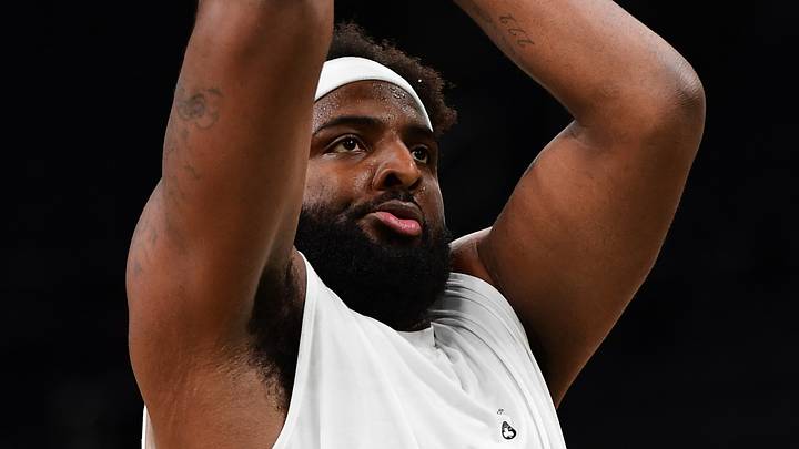 Oct 10, 2026; Boston, Massachusetts, USA; Current Boston Celtics and former New York Knicks center Mitchell Robinson (4) shoots the ball during warmups prior to a game against the Philadelphia 76ers at TD Garden. Mandatory Credit: Bob DeChiara-Imagn Images