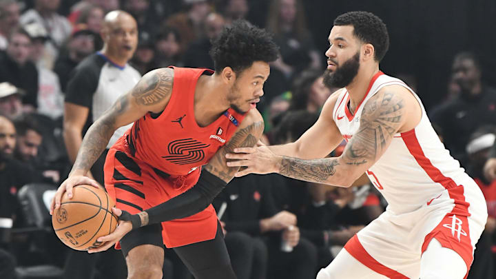 Jan 18, 2025; Portland, Oregon, USA;  Houston Rockets point guard Fred VanVleet (5) guards Portland Trail Blazers guard Anfernee Simons (1) during the first half at Moda Center. Mandatory Credit: Brian Murphy-Imagn Images