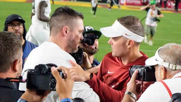 Oregon head coach Dan Lanning, left, shakes hands with USC head coach Lincoln Riley as the Oregon Ducks face the USC Trojans on Sept. 26, 2026, at Los Angeles Memorial Coliseum in Los Angeles, California.