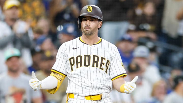 Jun 9, 2025; San Diego, California, USA; San Diego Padres left fielder Tyler Wade (14) celebrates after hitting a three run triple during the third inning against the Los Angeles Dodgers at Petco Park. Jun 9, 2025; San Diego, California, USA; San Diego Padres left fielder Tyler Wade (14) celebrates after hitting a three run triple during the third inning against the Los Angeles Dodgers at Petco Park.