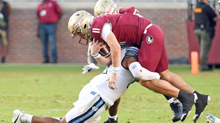Nov 2, 2024; Tallahassee, Florida, USA; Florida State Seminoes quarterback Brock Glenn (11) is sacked by the North Carolina Tarheels defense in the fourth quarter at Doak S. Campbell Stadium. Mandatory Credit: Robert Myers-Imagn Images Nov 2, 2024; Tallahassee, Florida, USA; Florida State Seminoes quarterback Brock Glenn (11) is sacked by the North Carolina Tarheels defense in the fourth quarter at Doak S. Campbell Stadium. Mandatory Credit: Robert Myers-Imagn Images