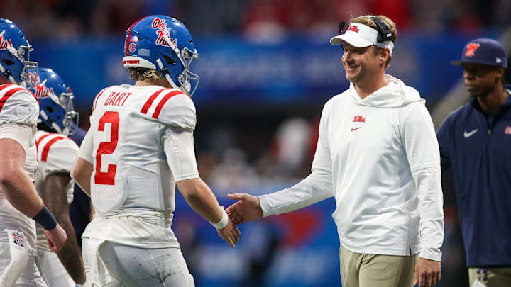 Dec 30, 2023; Atlanta, GA, USA; Mississippi Rebels head coach Lane Kiffin celebrates with quarterback Jaxson Dart (2) after a touchdown against the Penn State Nittany Lions in the second half at Mercedes-Benz Stadium. Mandatory Credit: Brett Davis-Imagn Images.