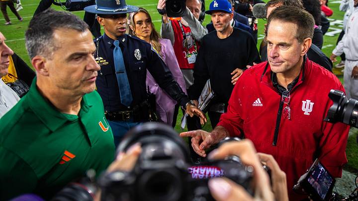 Jan 19, 2026; Miami Gardens, FL, USA; Indiana head coach Curt Cignetti and Miami head coach Mario Cristobal shake hands after the CFP National Championship college football game at Hard Rock Stadium. Mandatory Credit: Rich Janzaruk-USA TODAY Network via Imagn Images