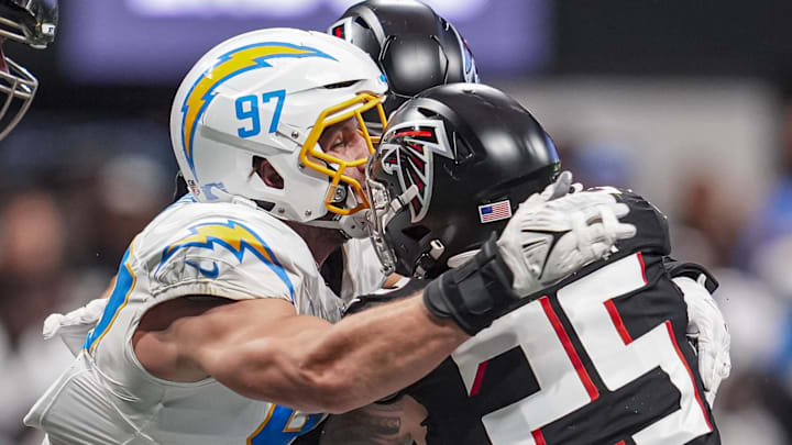 Dec 1, 2024; Atlanta, Georgia, USA; Atlanta Falcons running back Tyler Allgeier (25) is tackled by Los Angeles Chargers linebacker Joey Bosa (97) during the second half at Mercedes-Benz Stadium. Mandatory Credit: Dale Zanine-Imagn Images Dec 1, 2024; Atlanta, Georgia, USA; Atlanta Falcons running back Tyler Allgeier (25) is tackled by Los Angeles Chargers linebacker Joey Bosa (97) during the second half at Mercedes-Benz Stadium. Mandatory Credit: Dale Zanine-Imagn Images