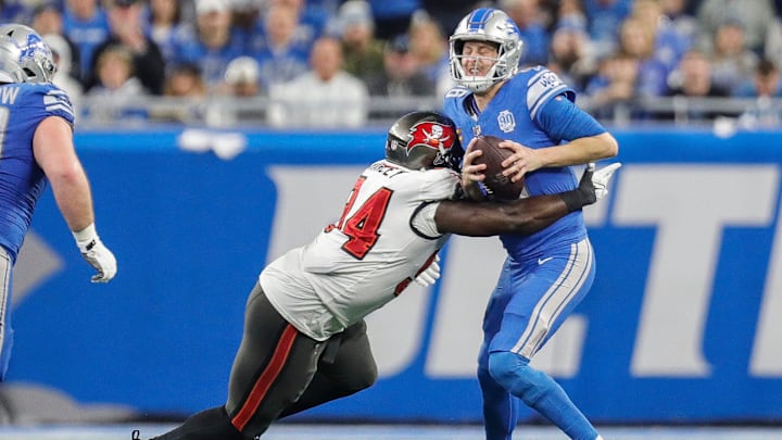Jan 21, 2024; Detroit, Michigan, USA; Detroit Lions quarterback Jared Goff (16) is sacked by Tampa Bay Buccaneers defensive tackle Calijah Kancey (94) during the first half in a 2024 NFC divisional round game at Ford Field. Mandatory Credit: Junfu Han-Imagn Images