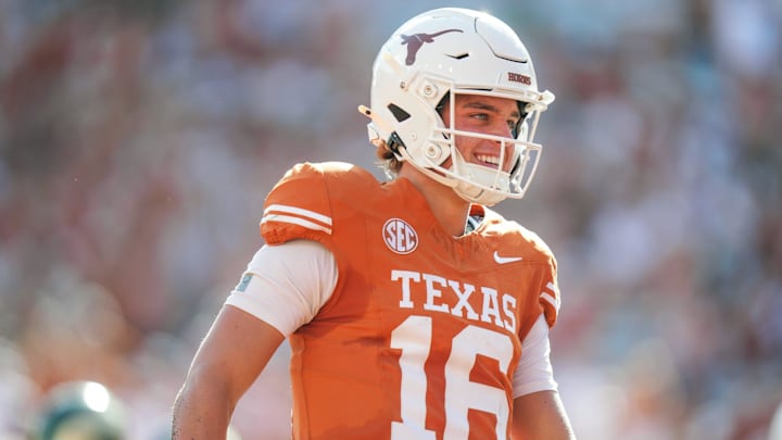 Texas Longhorns quarterback Arch Manning (16) smiles after scoring a touchdown