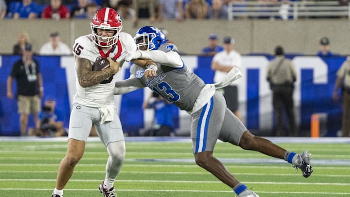 Sep 14, 2024; Lexington, Kentucky, USA; Kentucky Wildcats linebacker J.J. Weaver (13) attempts to sack Georgia Bulldogs quarterback Carson Beck (15) during the fourth quarter at Kroger Field. Mandatory Credit: Tanner Pearson-Imagn Images