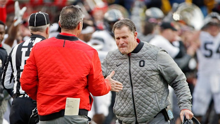 Ohio State Buckeyes head coach Urban Meyer shakes hands with defensive coordinator Greg Schiano.