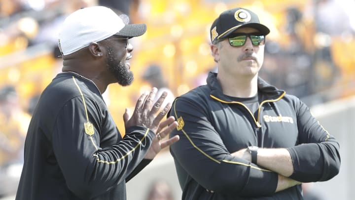 Sep 22, 2024; Pittsburgh, Pennsylvania, USA;  Pittsburgh Steelers head coach Mike Tomlin (left) and offensive coordinator Arthur Smith (right) talk on the field before the game against the Los Angeles Chargers at Acrisure Stadium. Mandatory Credit: Charles LeClaire-Imagn Images