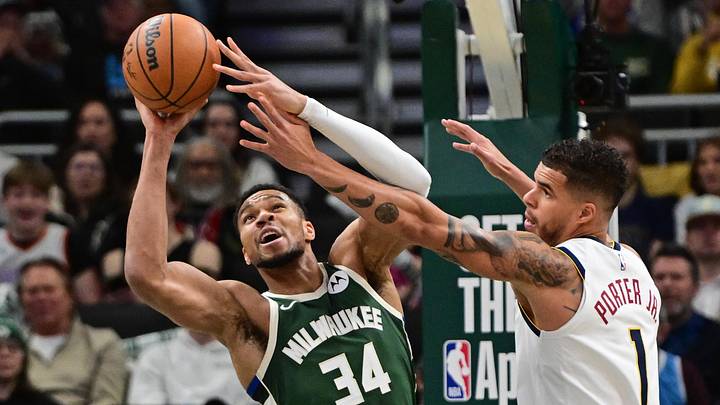 Feb 27, 2025; Milwaukee, Wisconsin, USA; Milwaukee Bucks forward Giannis Antetokounmpo (34) grabs a rebound against Denver Nuggets forward Michael Porter Jr. (1) in the first quarter at Fiserv Forum. Mandatory Credit: Benny Sieu-Imagn Images Feb 27, 2025; Milwaukee, Wisconsin, USA; Milwaukee Bucks forward Giannis Antetokounmpo (34) grabs a rebound against Denver Nuggets forward Michael Porter Jr. (1) in the first quarter at Fiserv Forum. Mandatory Credit: Benny Sieu-Imagn Images