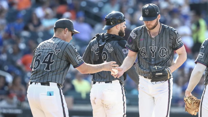 Jul 13, 2024; New York City, New York, USA;  New York Mets starting pitcher Christian Scott (45) is taken out of the game by manager Carlos Mendoza (64) in the fifth inning against the Colorado Rockies at Citi Field. Mandatory Credit: Wendell Cruz-USA TODAY Sports