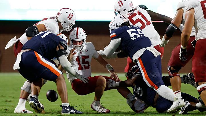 Sep 20, 2025; Charlottesville, Virginia, USA; Stanford Cardinal quarterback Ben Gulbranson (15) is stripped of the ball by Virginia Cavaliers linebacker Kam Robinson (5) after a hit by Cavaliers defensive tackle Anthony Britton (55) during the fourth quarter at Scott Stadium. Mandatory Credit: Geoff Burke-Imagn Images Sep 20, 2025; Charlottesville, Virginia, USA; Stanford Cardinal quarterback Ben Gulbranson (15) is stripped of the ball by Virginia Cavaliers linebacker Kam Robinson (5) after a hit by Cavaliers defensive tackle Anthony Britton (55) during the fourth quarter at Scott Stadium. Mandatory Credit: Geoff Burke-Imagn Images