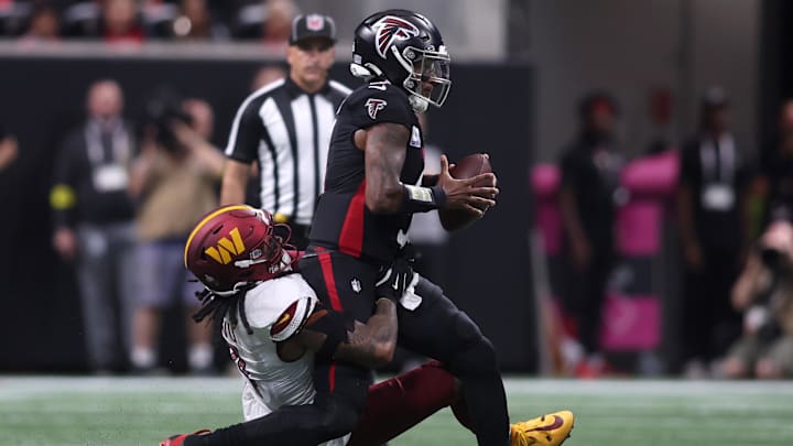 Sep 28, 2025; Atlanta, Georgia, USA; Washington Commanders linebacker Frankie Luvu (4) sacks Atlanta Falcons quarterback Michael Penix Jr. (9) during the first half at Mercedes-Benz Stadium. Mandatory Credit: Brett Davis-Imagn Images